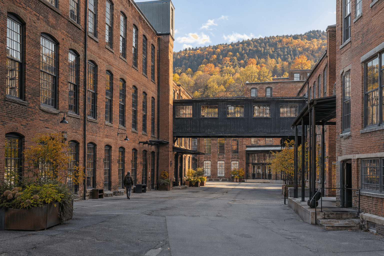 Illustration inspired by MASS MoCA, with red brick mill buildings around an industrial courtyard