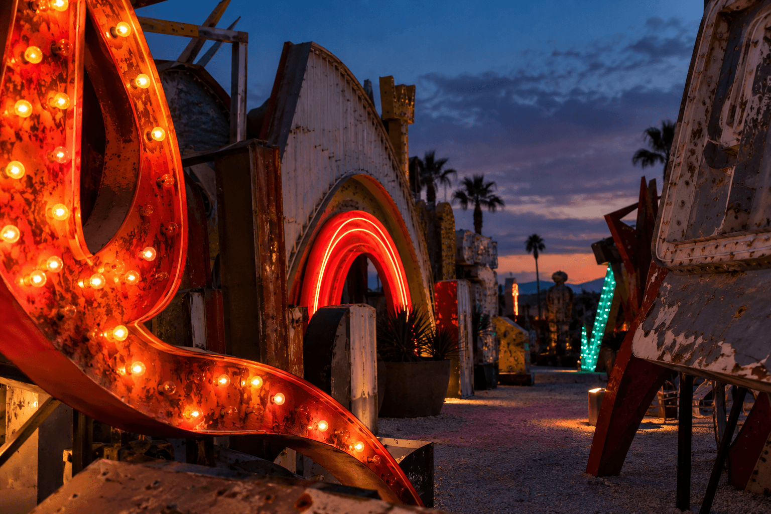 Illustration inspired by the Neon Boneyard, with weathered vintage signs glowing at dusk